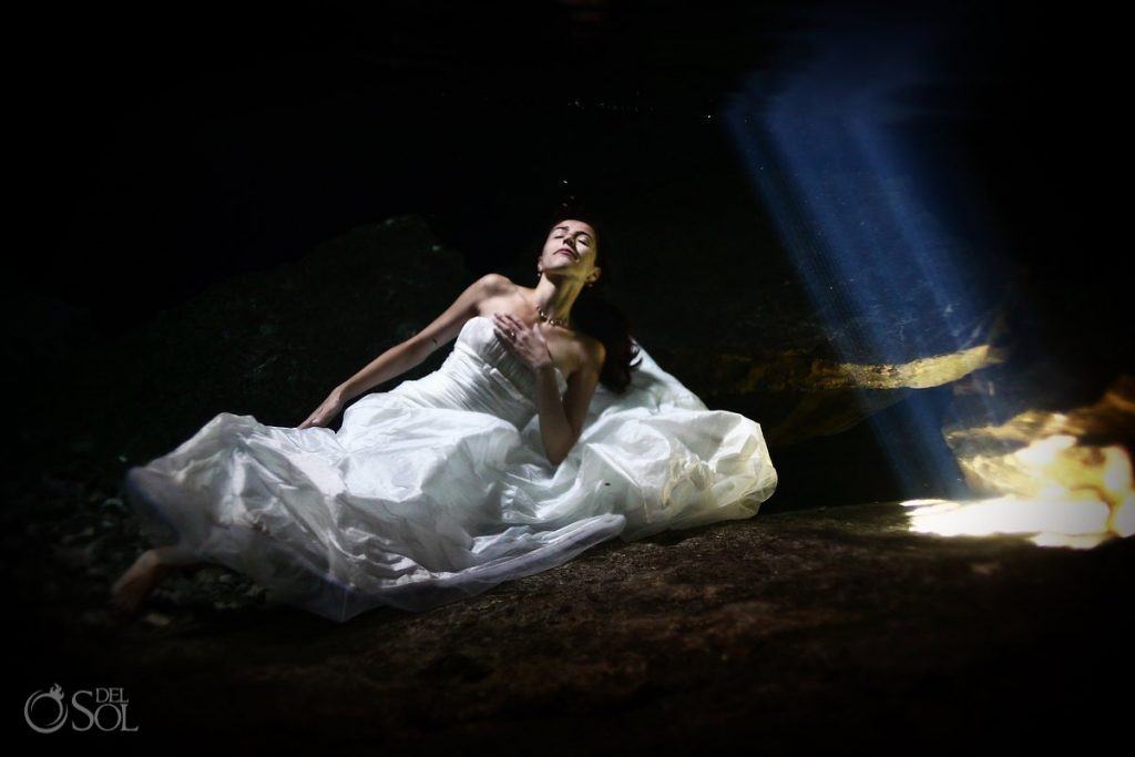It's hard to believe this bride is actually underwater for this amazing moment in time captured on film. bride in the water on trash the dress.