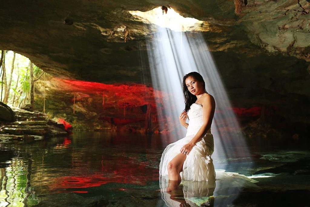 The light streaming in over this bride with a vibrant red reflection creates this work of art Trash the Dress image 5 work of art del sol picture