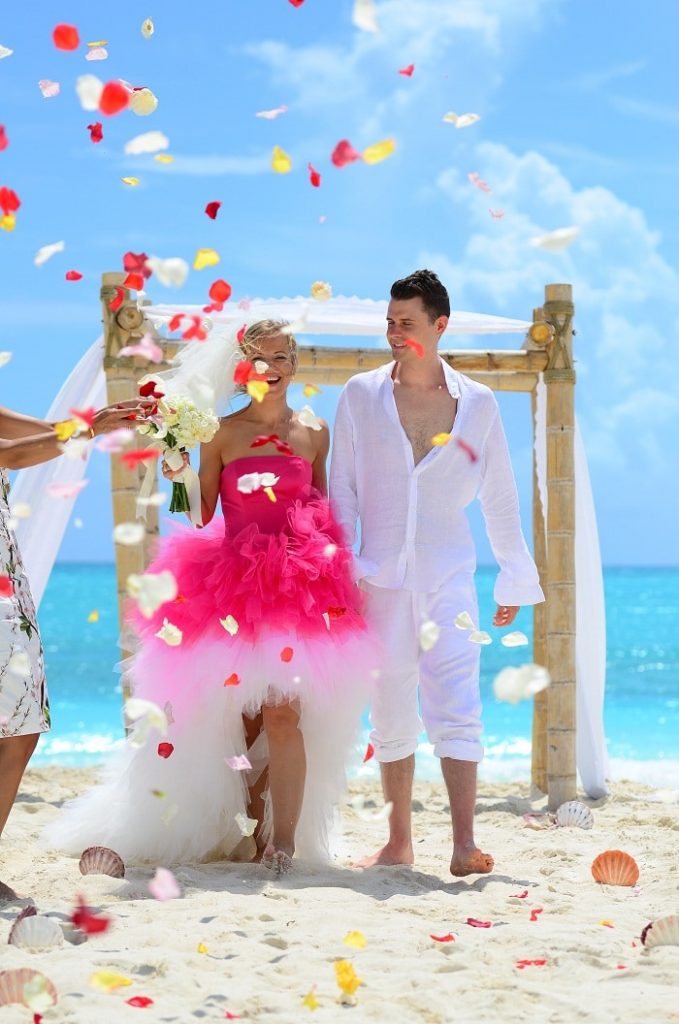  couple getting flowers thrown after ceremony 