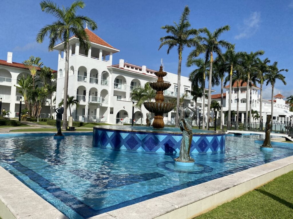 infinity pool, resort and palm trees