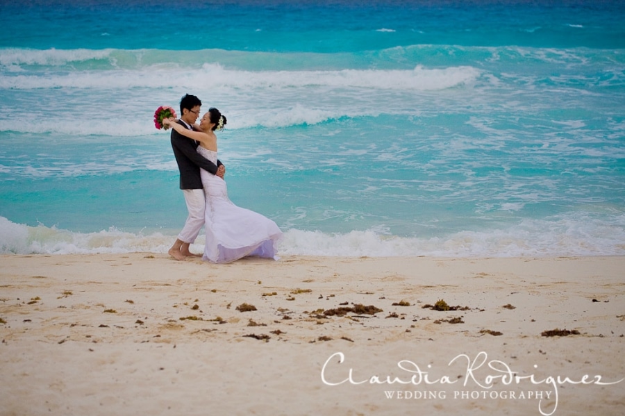 Action shot of bride and groom on the beach