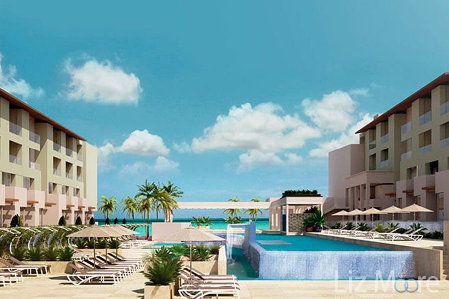 Main pool with infinity pool Water fountain Lounge chairs and room buildings