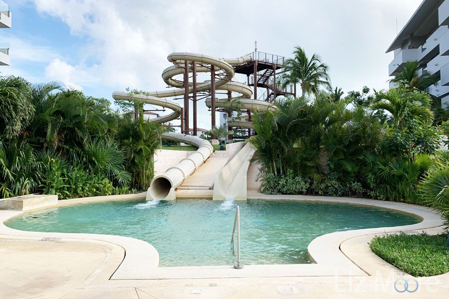 Resort waterslide area with tubes going down into water area