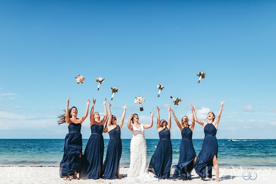 bridesmaids on beach With the bride throwing bouquets in the air