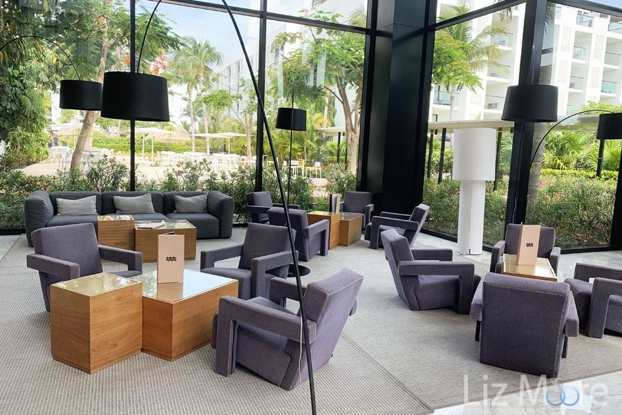 lounge sitting area With comfortable purple couches and tables for drinks
