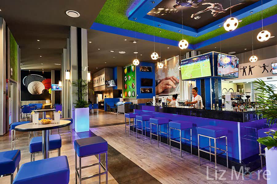 main sports bar decorated and purple Decor with ceiling lights in the shape of soccer balls