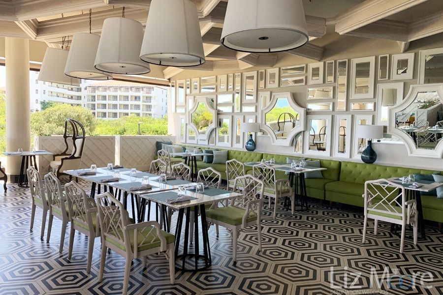 Helios Beach Restaurant With open air concept Spiral tile flooring and beautiful white chandeliers