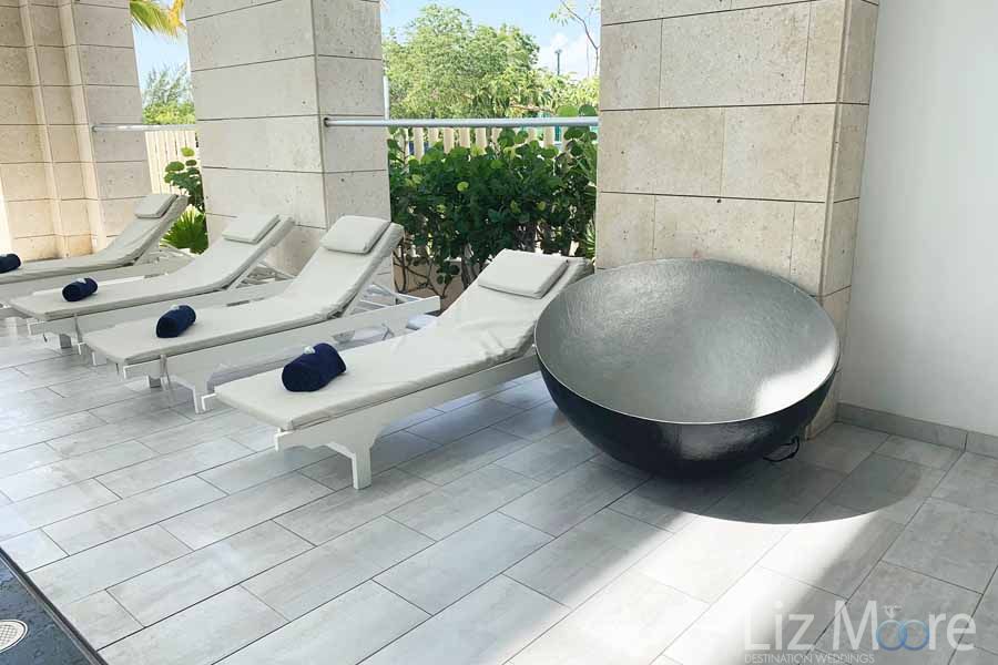 Spot lounge area with beautiful silver decor tub white tiling and white lounge chairs