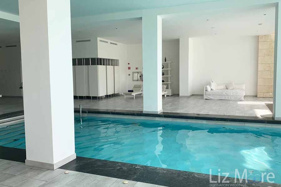 Main swimming pool located in doors in the spa with surrounding lounge chairs