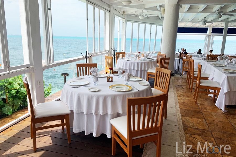 Over the water restaurant With brown wooden chairs and view of the ocean