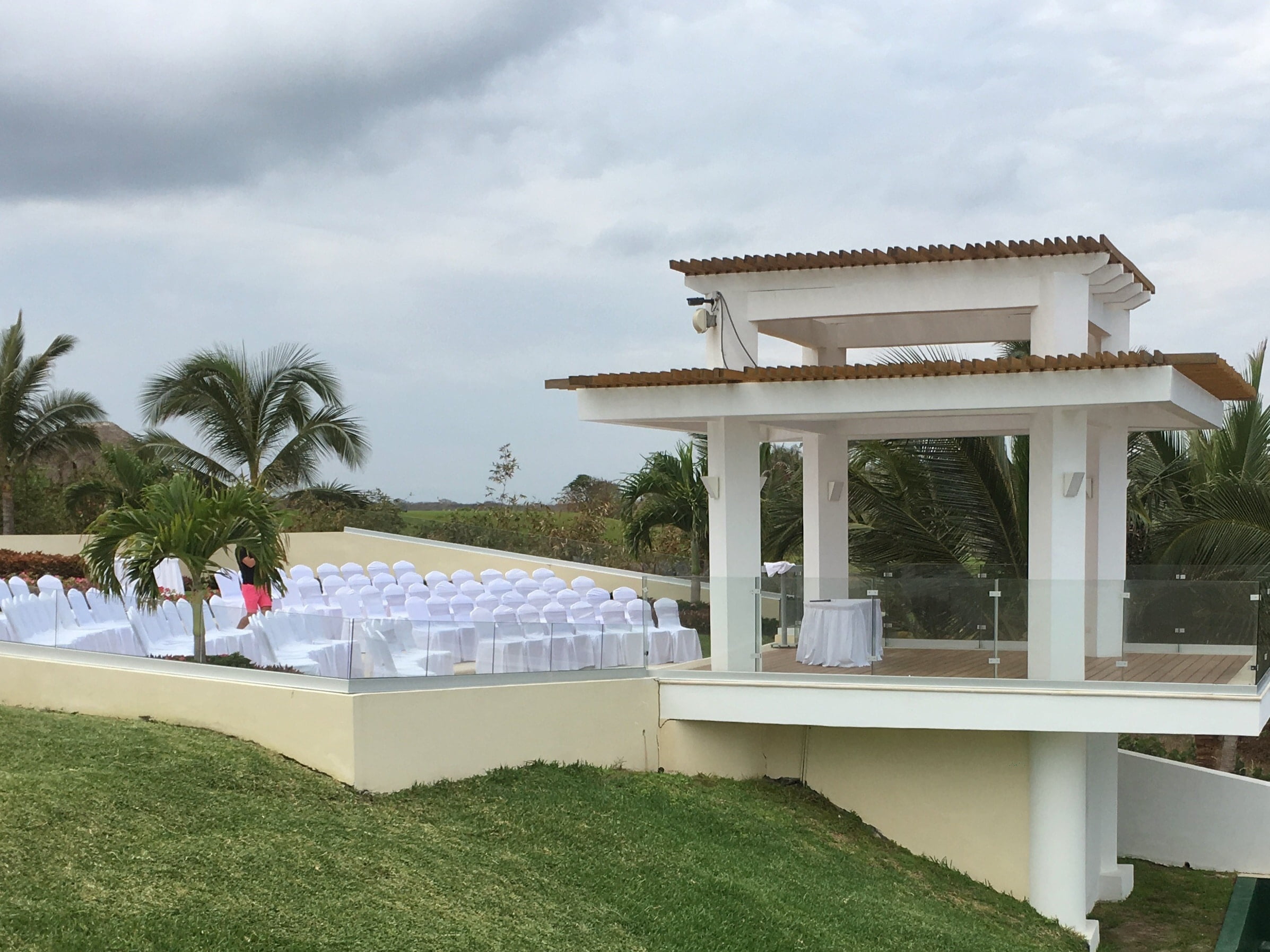main wedding gazebo with chairs and tables set up for wedding ceremony by the lawn